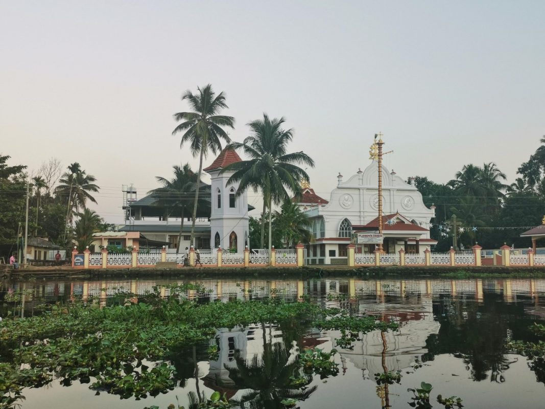 christelijke kerk met water en planten en een blauwe lucht in India 